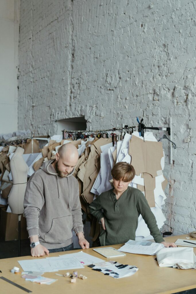 Designers working together on fashion concepts in a modern studio setting.